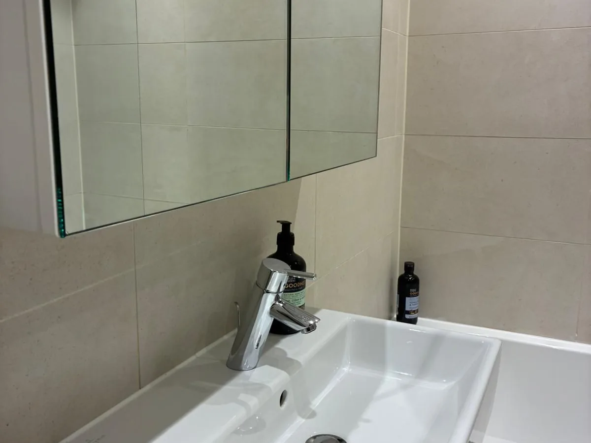 Clean bathroom basin and mirror after a regular domestic clean